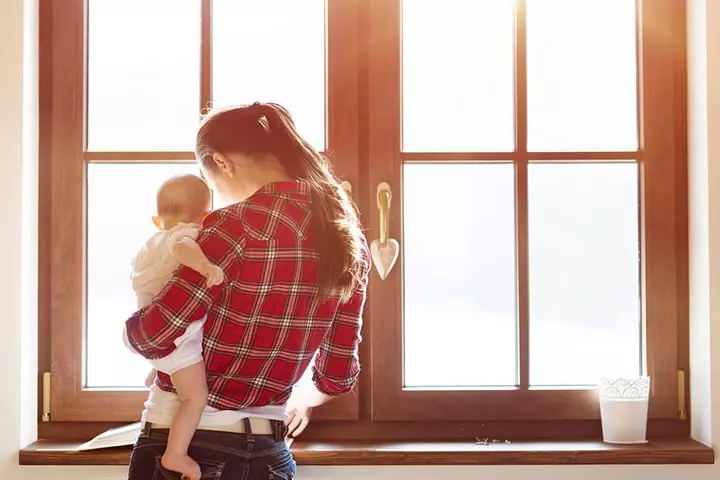 Take the baby in your arms from behind