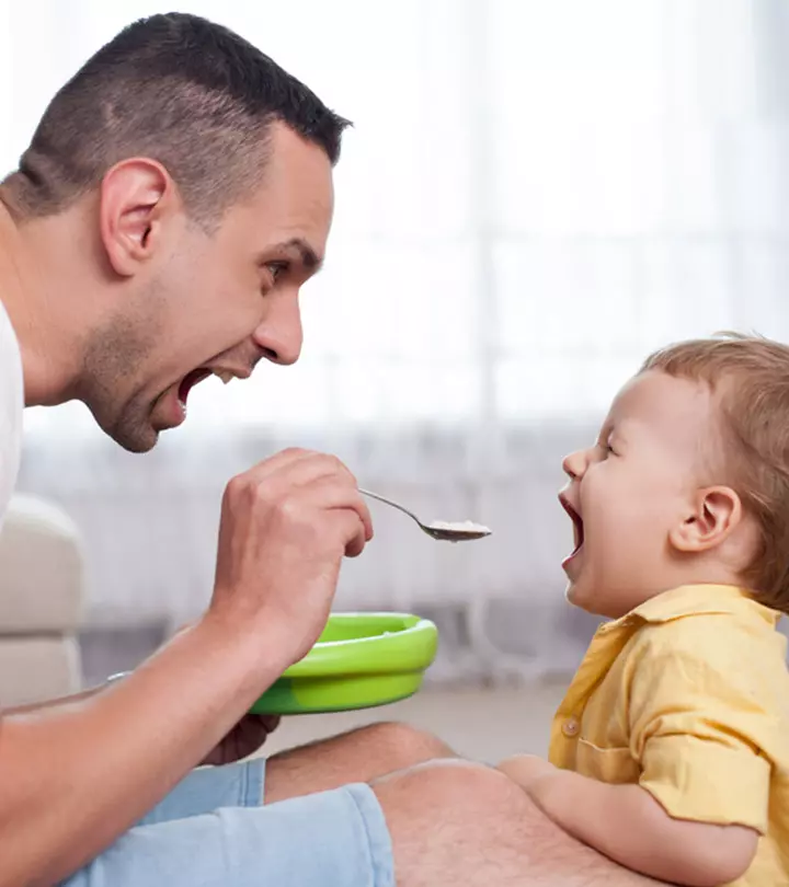 Father Feeding Semolina To Baby