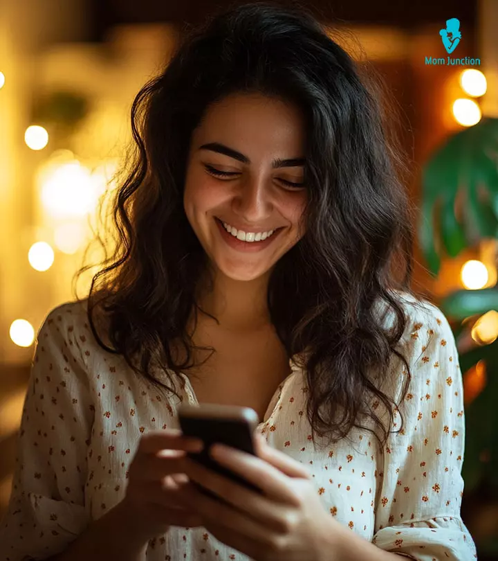 Woman smiling while reading a text message from a guy