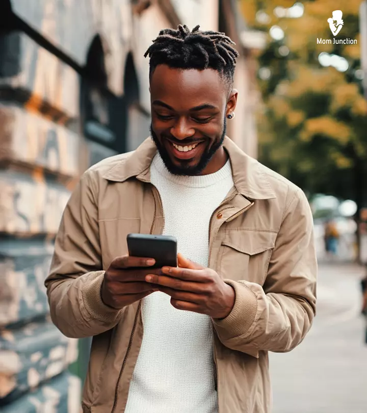 Man happily reading a text message from a girl