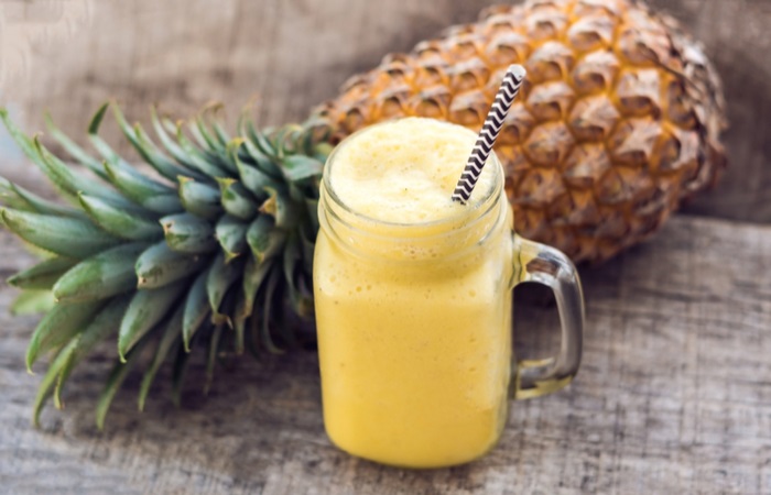 pineapple-smoothie-fresh-on-wooden-table-776968468.jpg