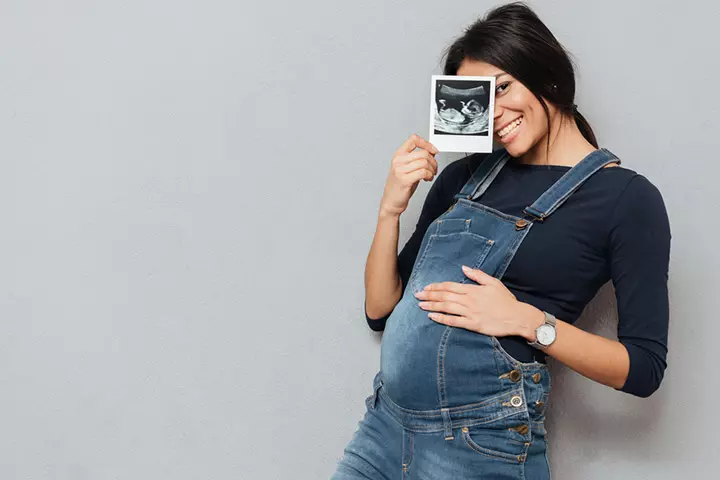 holding ultrasound picture in hand