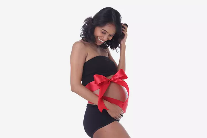 tying a gift ribbon to your baby bump