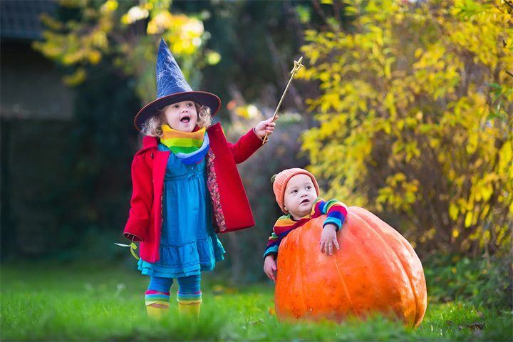 Elder sibling with baby in a pumpkin pictures