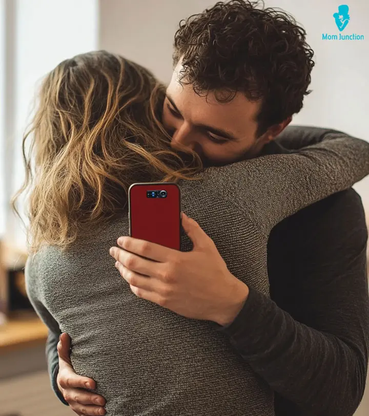 Woman-Hugging-Her-Man-And-Texting-On-Phone