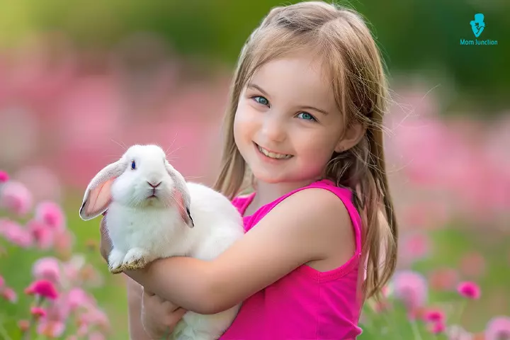 A child holding a rabbit