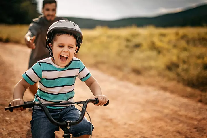 Father teaching his son to ride a bicycle