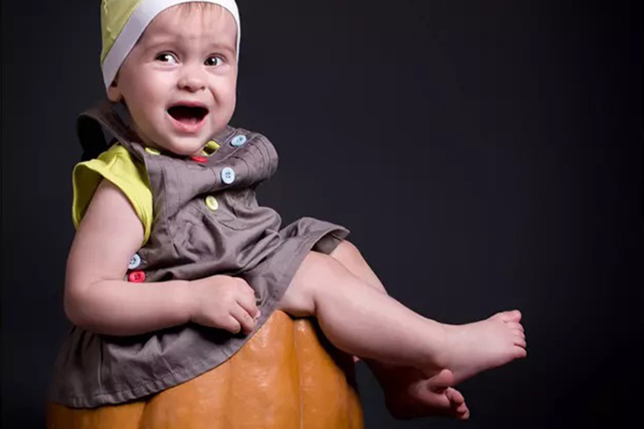 Smiling and happy baby in a pumpkin pictures