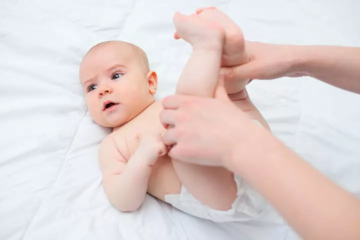 Constipated baby releases abdominal gas while passing stools