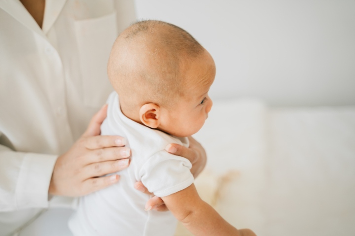 Prevent colic by making the baby burp