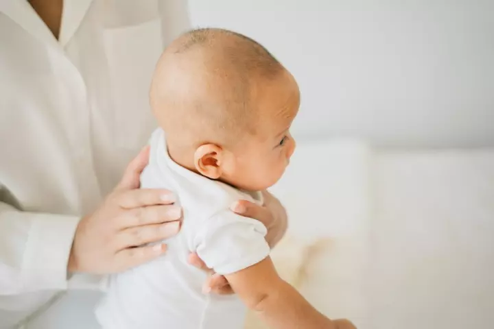 Prevent colic by making the baby burp