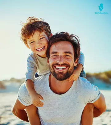 Father And Son Playing At Beach