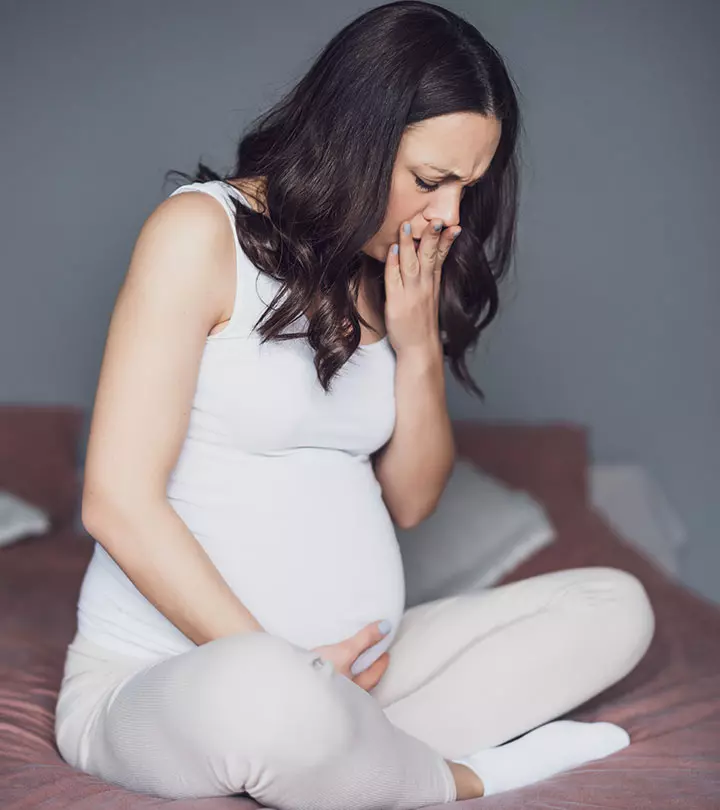 Pregnant woman burping due to heartburn