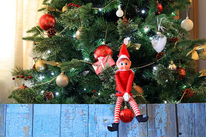 The Elf on the Shelf climbs the Christmas tree