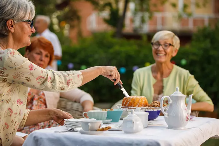 70 year old woman celebrating birthday with friends