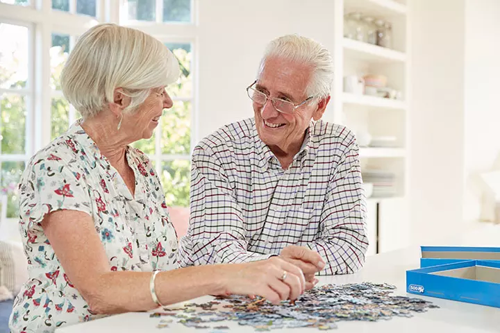 Couple solving jigsaw puzzles