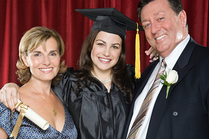 Parents posing for a picture with graduating daughter