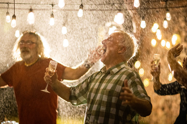 Senior men dancing in the rain