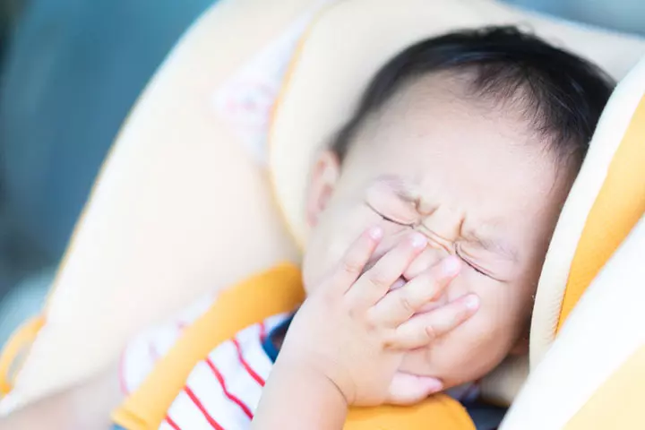 Babies may have cold-like symptoms such as cough and sneezing.