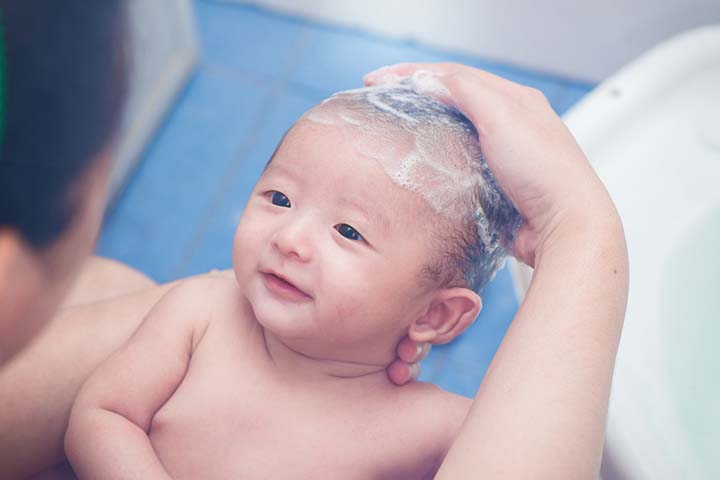Carefully shampoo baby's hair