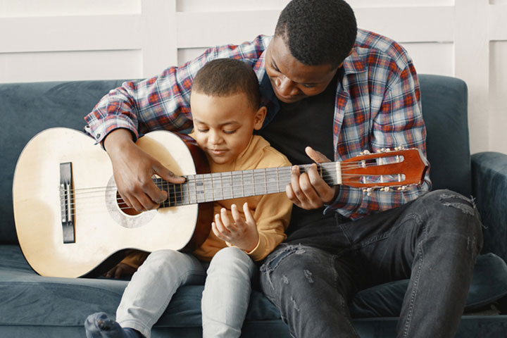 Father and son playing the guitar