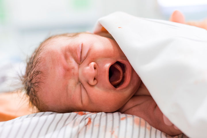 Neonates may spit pink-tinged flecks due to swallowed maternal blood during delivery