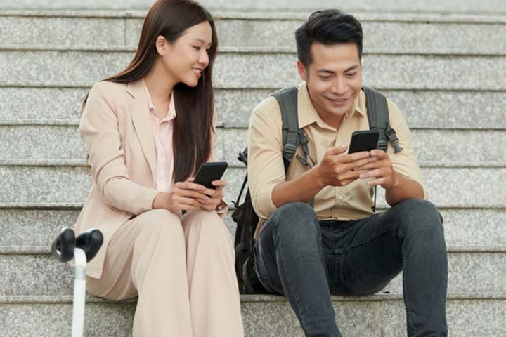 Couple smiling while texting
