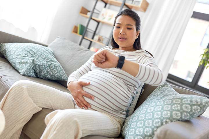 Pregnant woman timing contractions
