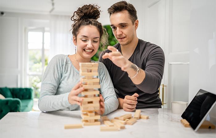 Chinese Boyfriend And Girlfriend Playing Video Games Sitting At